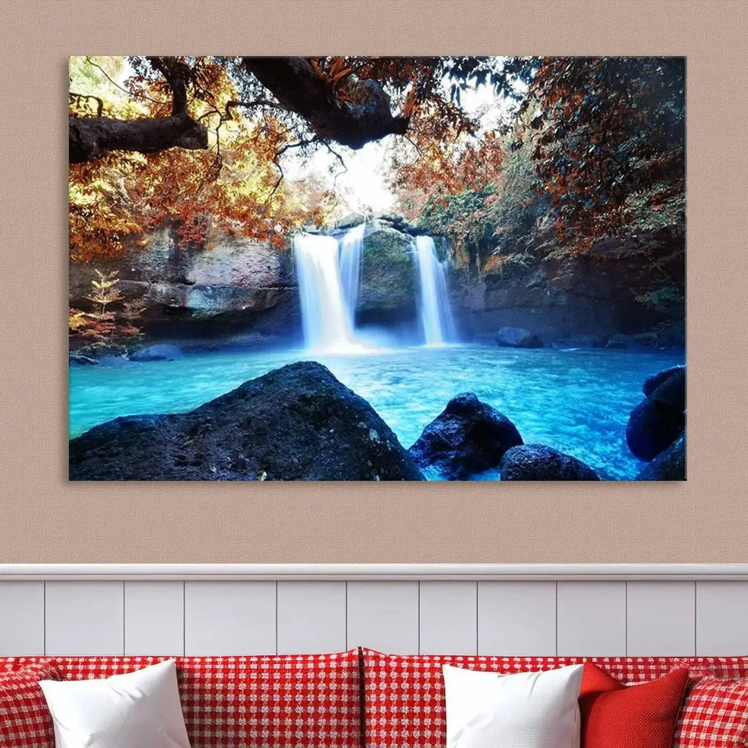 In the living room, a hand-assembled triptych titled "Wall Art Waterfall Canvas Print Great Double Waterfalls with Bright Water in Forest" is displayed on museum-quality canvas.