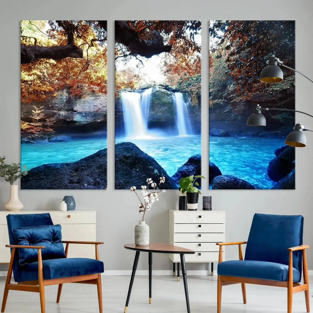 In the living room, a hand-assembled triptych titled "Wall Art Waterfall Canvas Print Great Double Waterfalls with Bright Water in Forest" is displayed on museum-quality canvas.