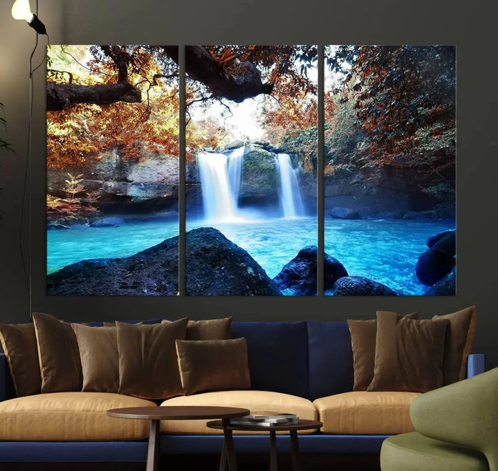 In the living room, a hand-assembled triptych titled "Wall Art Waterfall Canvas Print Great Double Waterfalls with Bright Water in Forest" is displayed on museum-quality canvas.