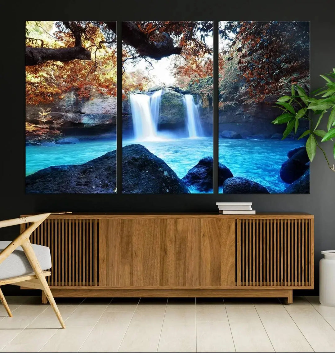 In the living room, a hand-assembled triptych titled "Wall Art Waterfall Canvas Print Great Double Waterfalls with Bright Water in Forest" is displayed on museum-quality canvas.