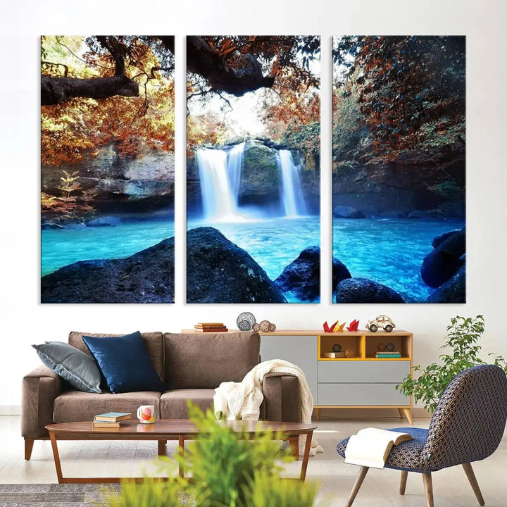 In the living room, a hand-assembled triptych titled "Wall Art Waterfall Canvas Print Great Double Waterfalls with Bright Water in Forest" is displayed on museum-quality canvas.