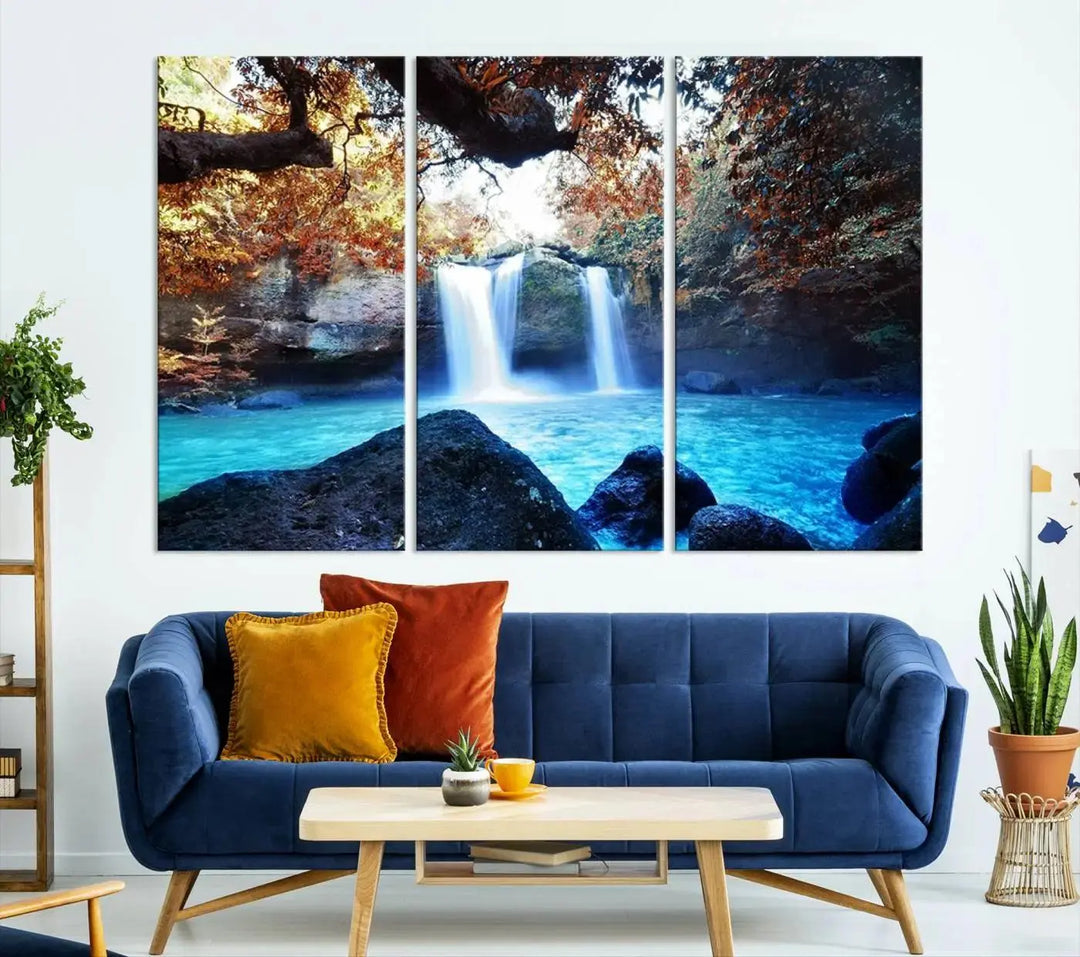 In the living room, a hand-assembled triptych titled "Wall Art Waterfall Canvas Print Great Double Waterfalls with Bright Water in Forest" is displayed on museum-quality canvas.