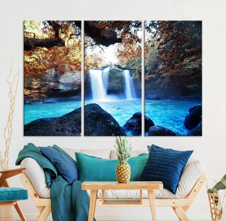 In the living room, a hand-assembled triptych titled "Wall Art Waterfall Canvas Print Great Double Waterfalls with Bright Water in Forest" is displayed on museum-quality canvas.