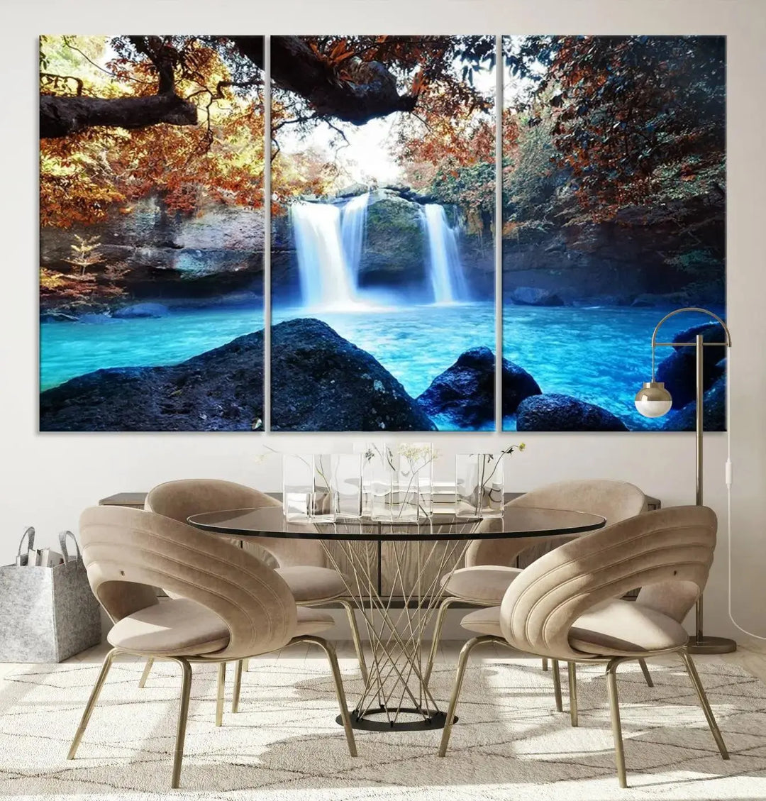 In the living room, a hand-assembled triptych titled "Wall Art Waterfall Canvas Print Great Double Waterfalls with Bright Water in Forest" is displayed on museum-quality canvas.