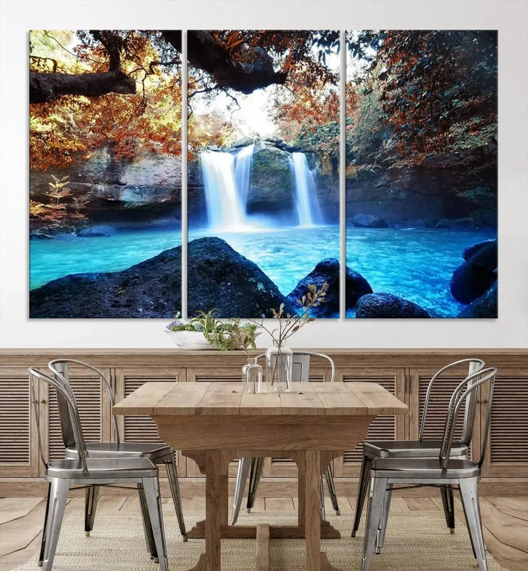 In the living room, a hand-assembled triptych titled "Wall Art Waterfall Canvas Print Great Double Waterfalls with Bright Water in Forest" is displayed on museum-quality canvas.