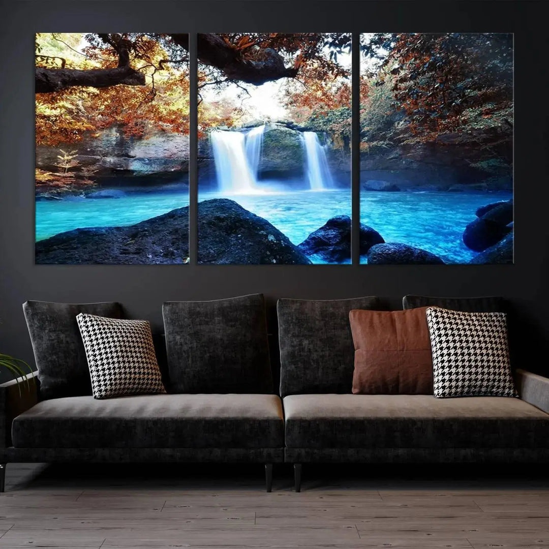 In the living room, a hand-assembled triptych titled "Wall Art Waterfall Canvas Print Great Double Waterfalls with Bright Water in Forest" is displayed on museum-quality canvas.