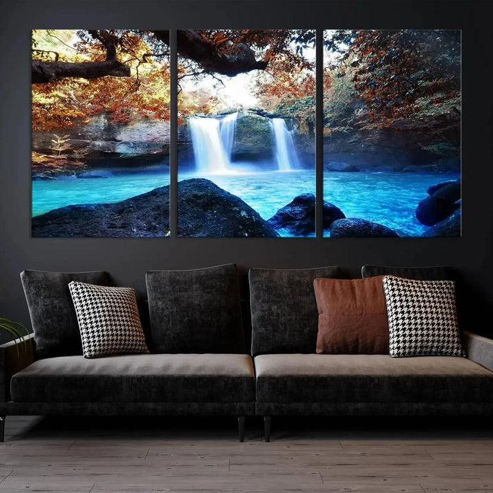 In the living room, a hand-assembled triptych titled "Wall Art Waterfall Canvas Print Great Double Waterfalls with Bright Water in Forest" is displayed on museum-quality canvas.