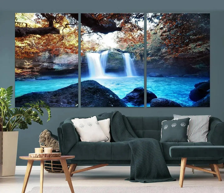 In the living room, a hand-assembled triptych titled "Wall Art Waterfall Canvas Print Great Double Waterfalls with Bright Water in Forest" is displayed on museum-quality canvas.