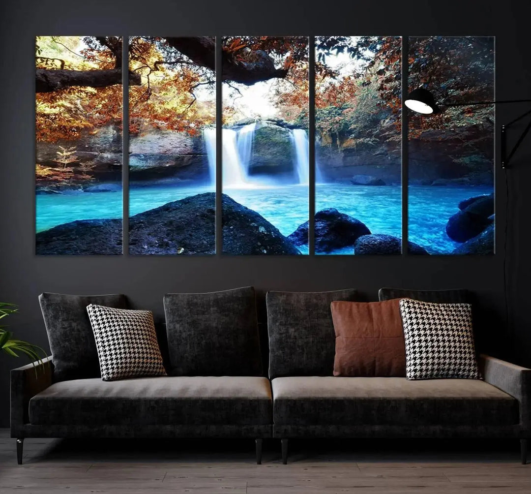 In the living room, a hand-assembled triptych titled "Wall Art Waterfall Canvas Print Great Double Waterfalls with Bright Water in Forest" is displayed on museum-quality canvas.