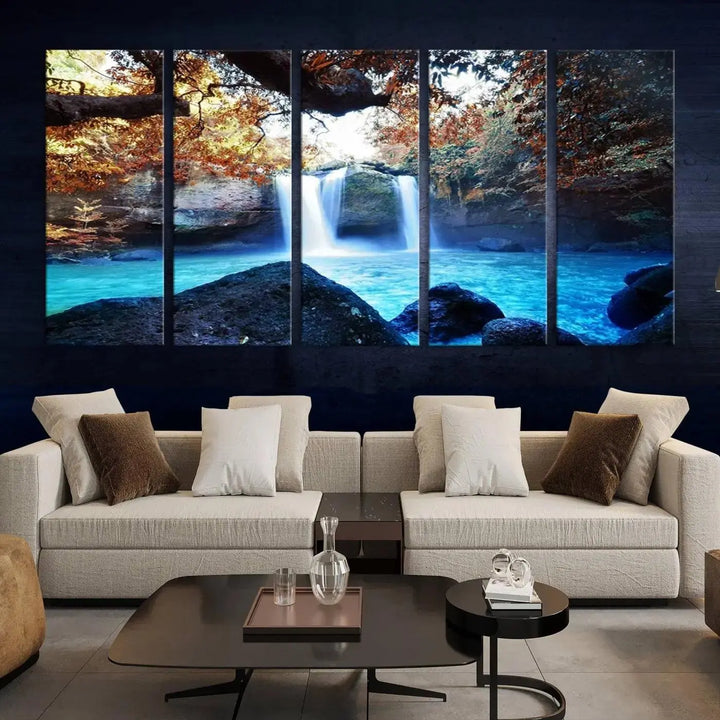 In the living room, a hand-assembled triptych titled "Wall Art Waterfall Canvas Print Great Double Waterfalls with Bright Water in Forest" is displayed on museum-quality canvas.