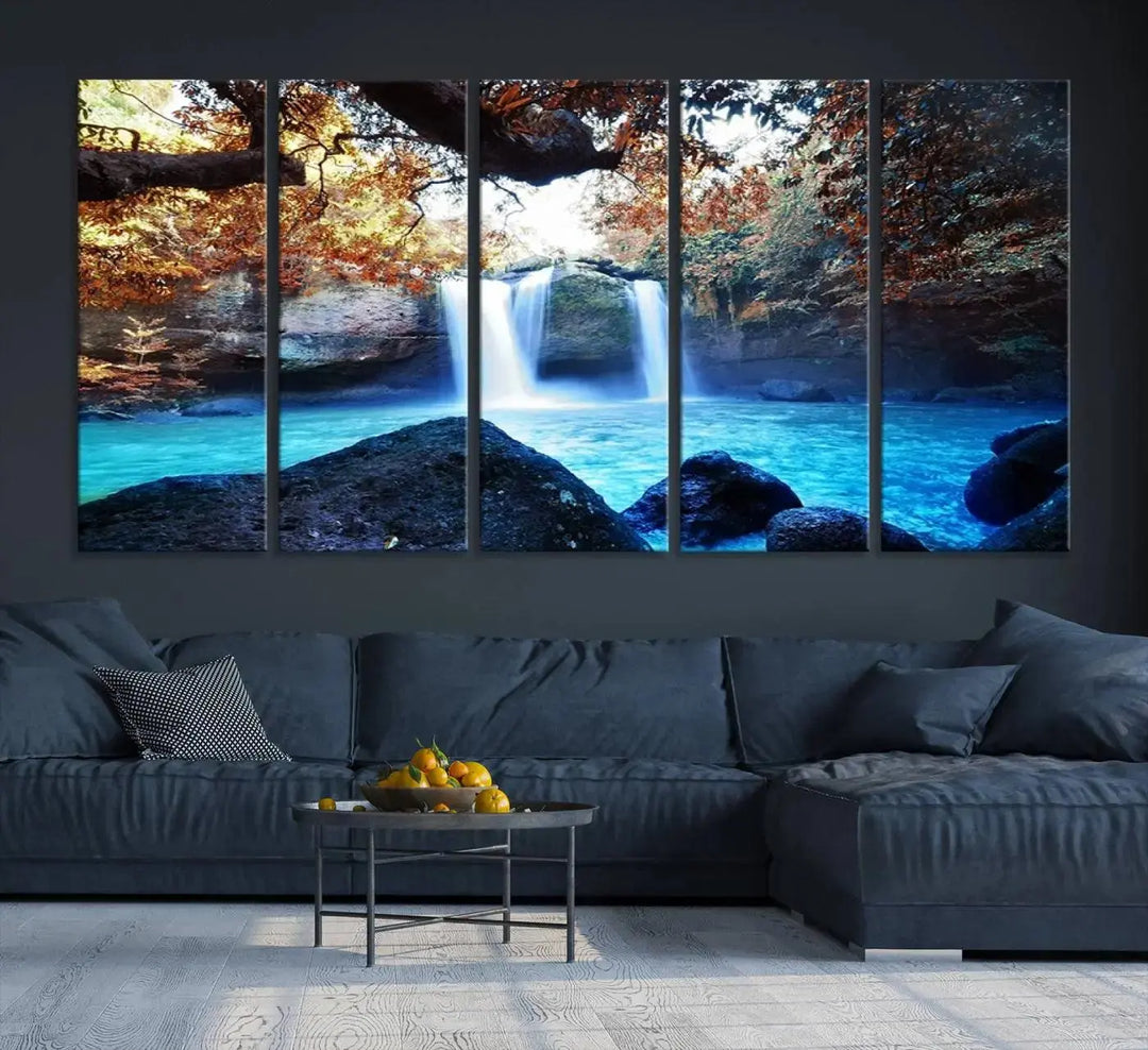 In the living room, a hand-assembled triptych titled "Wall Art Waterfall Canvas Print Great Double Waterfalls with Bright Water in Forest" is displayed on museum-quality canvas.