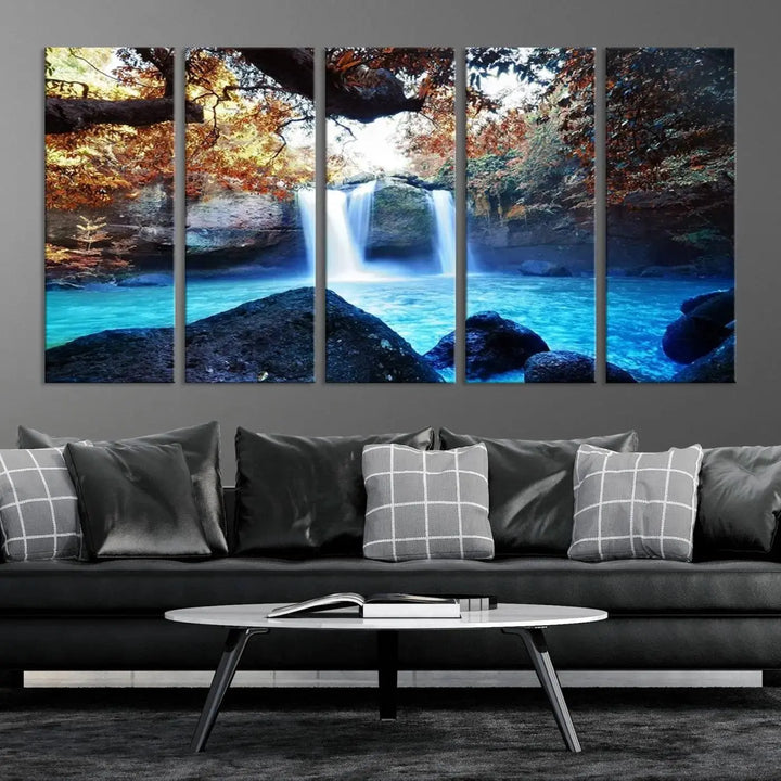 In the living room, a hand-assembled triptych titled "Wall Art Waterfall Canvas Print Great Double Waterfalls with Bright Water in Forest" is displayed on museum-quality canvas.