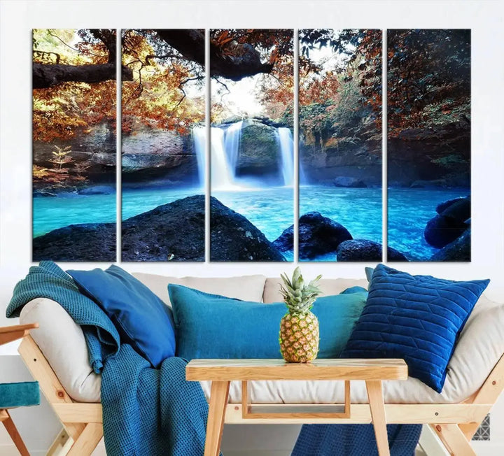 In the living room, a hand-assembled triptych titled "Wall Art Waterfall Canvas Print Great Double Waterfalls with Bright Water in Forest" is displayed on museum-quality canvas.