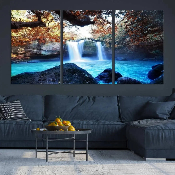 In the living room, a hand-assembled triptych titled "Wall Art Waterfall Canvas Print Great Double Waterfalls with Bright Water in Forest" is displayed on museum-quality canvas.