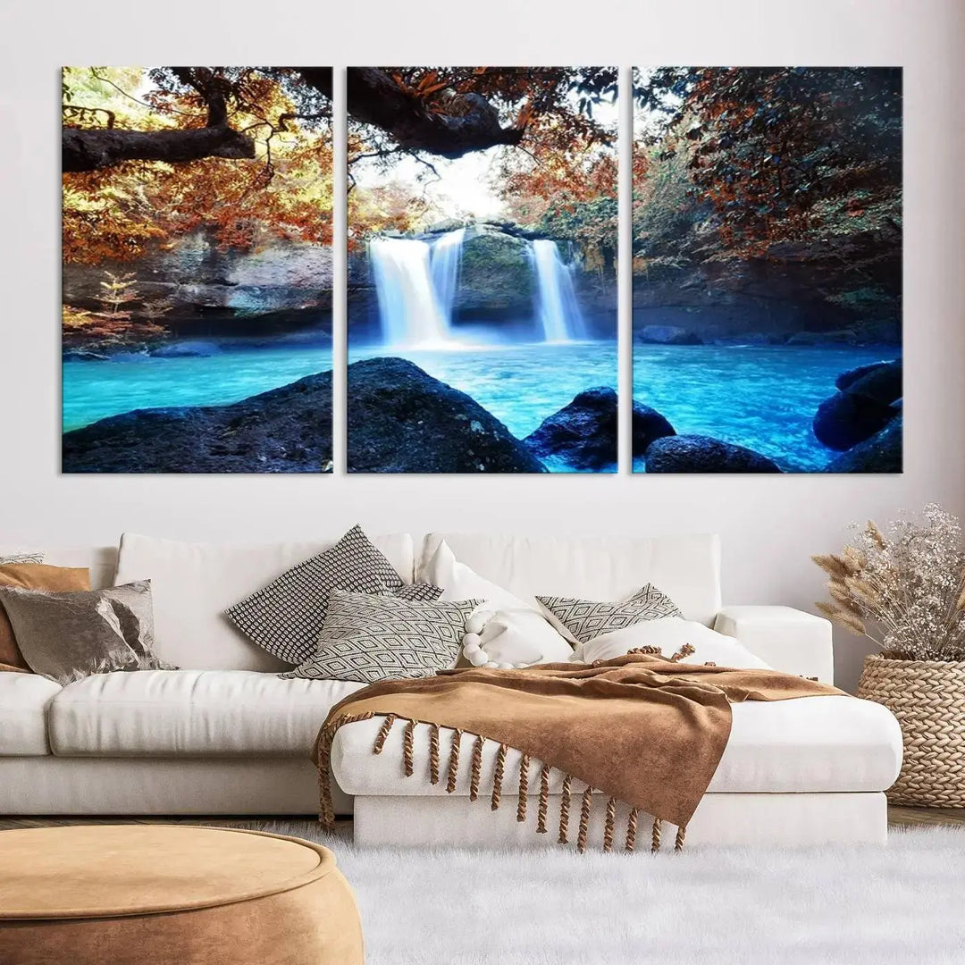 In the living room, a hand-assembled triptych titled "Wall Art Waterfall Canvas Print Great Double Waterfalls with Bright Water in Forest" is displayed on museum-quality canvas.