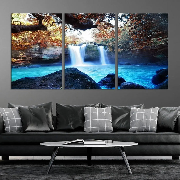 In the living room, a hand-assembled triptych titled "Wall Art Waterfall Canvas Print Great Double Waterfalls with Bright Water in Forest" is displayed on museum-quality canvas.