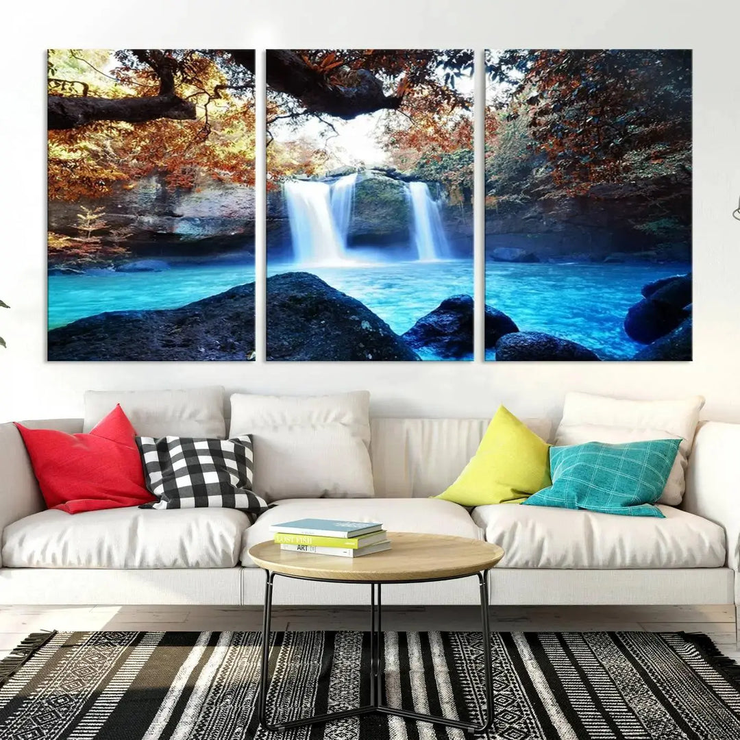 In the living room, a hand-assembled triptych titled "Wall Art Waterfall Canvas Print Great Double Waterfalls with Bright Water in Forest" is displayed on museum-quality canvas.