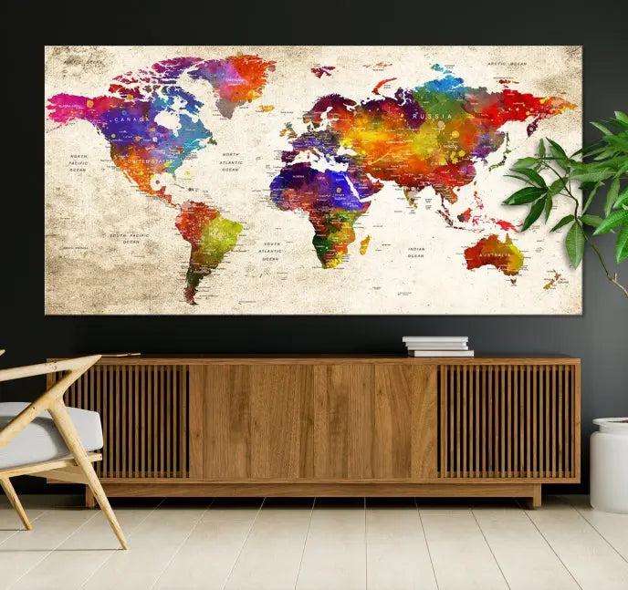 The Wall Art World Map Canvas Print features a three-panel design with vibrant colors and is coated with UV protection for museum quality, creating a stunning focal point in an elegantly styled, neutral-toned living room.