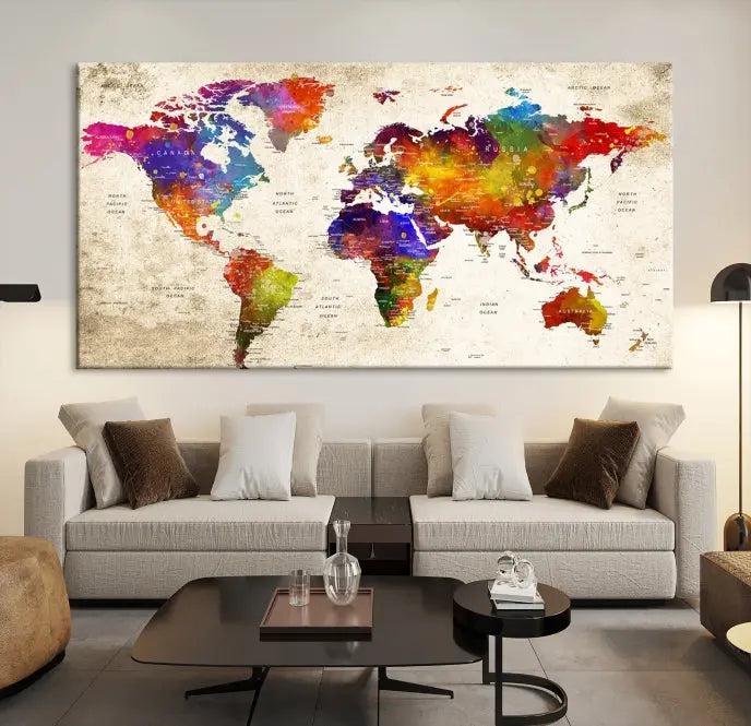 The Wall Art World Map Canvas Print features a three-panel design with vibrant colors and is coated with UV protection for museum quality, creating a stunning focal point in an elegantly styled, neutral-toned living room.