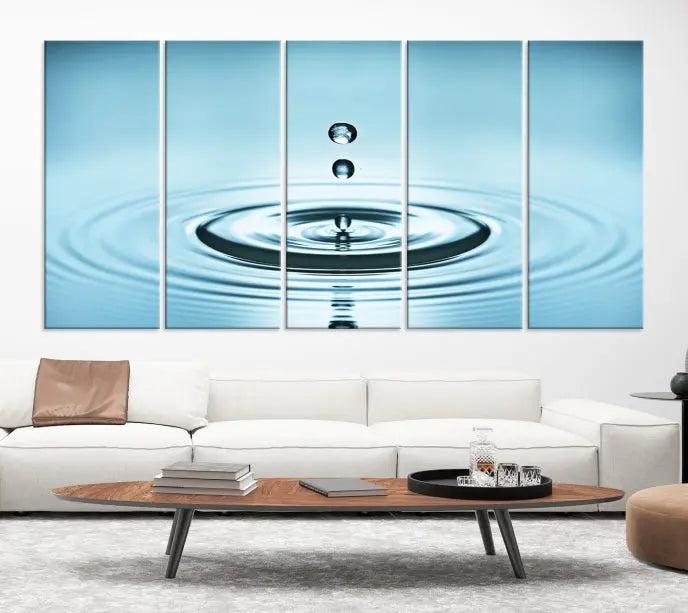 Modern living room featuring the "Water Drop Wall Art Canvas Print" depicting water droplets above ripples on museum-quality canvas on the wall.