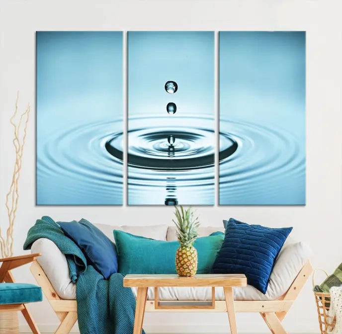 A modern living room showcases a gallery-wrapped triptych of the Water Droplet Wall Art Canvas Print.