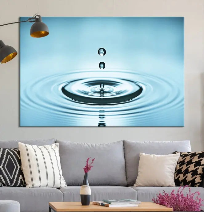 A modern living room showcases a gallery-wrapped triptych of the Water Droplet Wall Art Canvas Print.