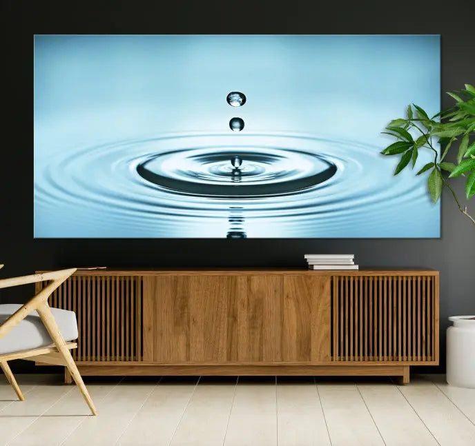 A modern living room showcases a gallery-wrapped triptych of the Water Droplet Wall Art Canvas Print.