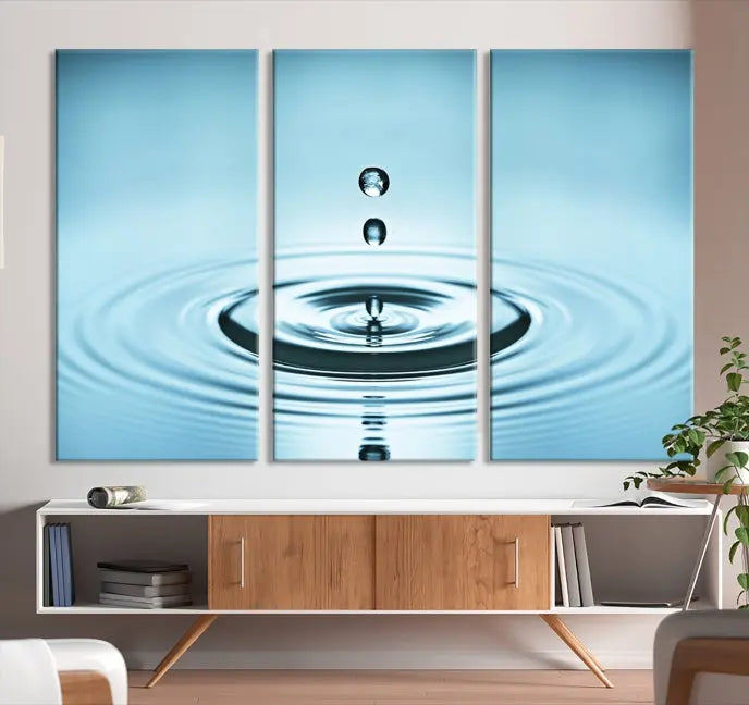 A modern living room showcases a gallery-wrapped triptych of the Water Droplet Wall Art Canvas Print.