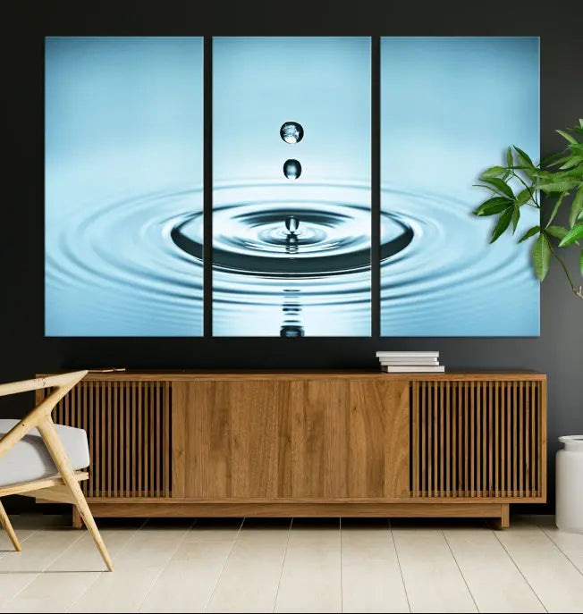 A modern living room showcases a gallery-wrapped triptych of the Water Droplet Wall Art Canvas Print.