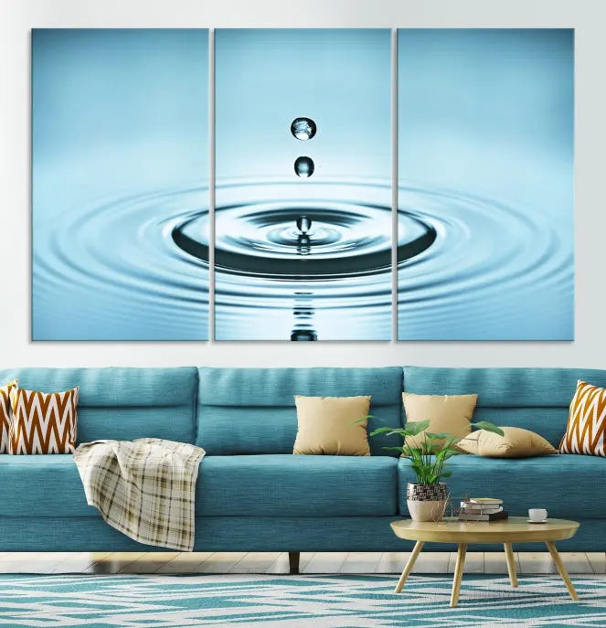 A modern living room showcases a gallery-wrapped triptych of the Water Droplet Wall Art Canvas Print.