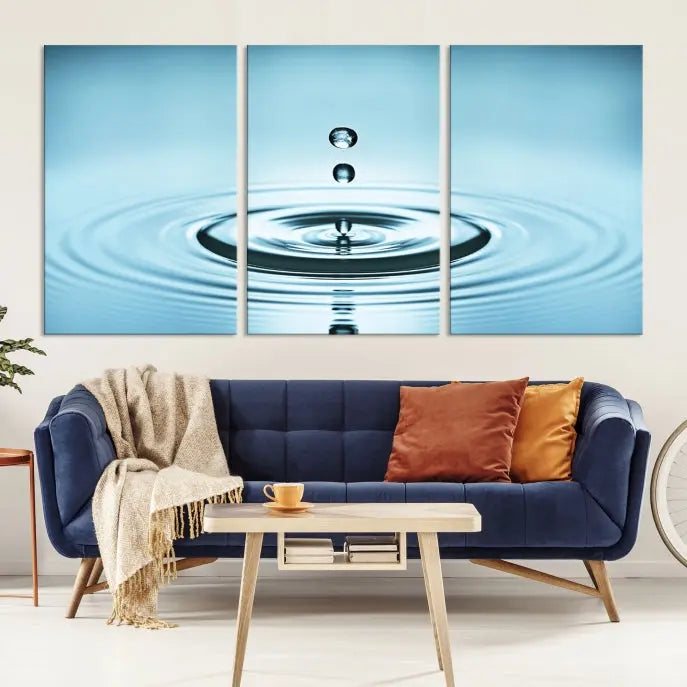 A modern living room showcases a gallery-wrapped triptych of the Water Droplet Wall Art Canvas Print.