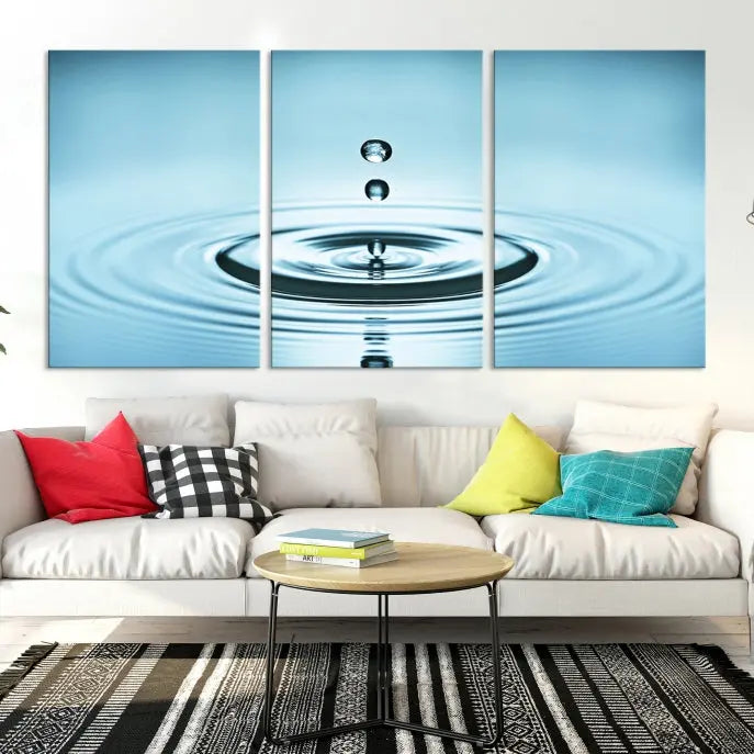 A modern living room showcases a gallery-wrapped triptych of the Water Droplet Wall Art Canvas Print.