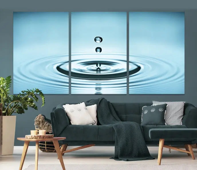 A modern living room showcases a gallery-wrapped triptych of the Water Droplet Wall Art Canvas Print.