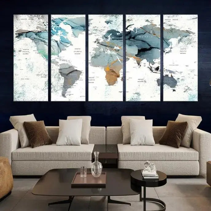 The Watercolor Push Pin World Map Wall Art, a world map painting on museum-quality canvas in blue and gray hues with a UV-protective coating, hangs prominently in the room.