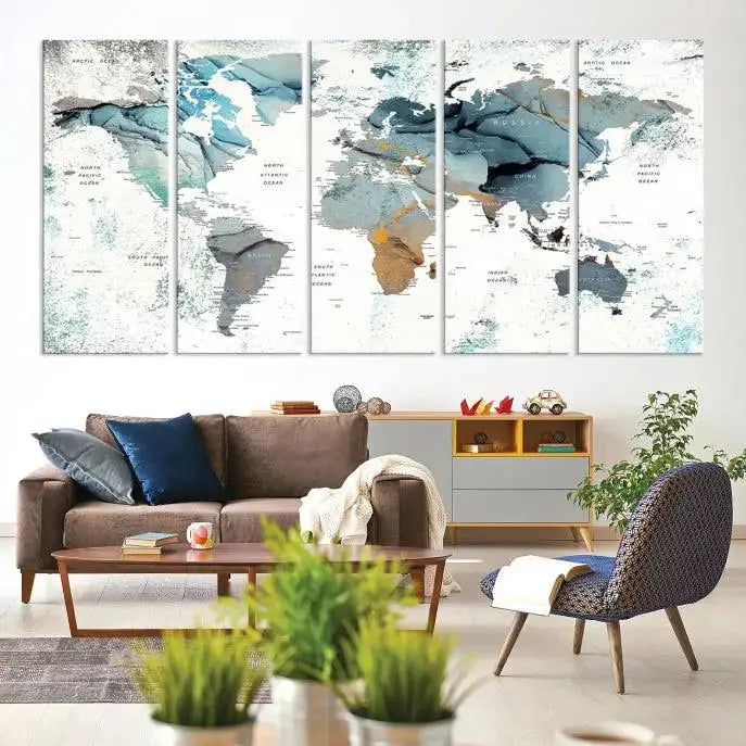 The Watercolor Push Pin World Map Wall Art, a world map painting on museum-quality canvas in blue and gray hues with a UV-protective coating, hangs prominently in the room.