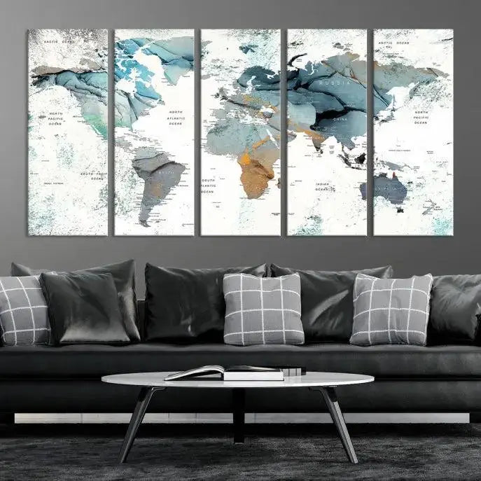 The Watercolor Push Pin World Map Wall Art, a world map painting on museum-quality canvas in blue and gray hues with a UV-protective coating, hangs prominently in the room.
