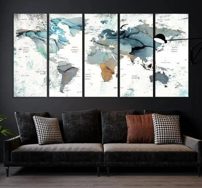 The Watercolor Push Pin World Map Wall Art, a world map painting on museum-quality canvas in blue and gray hues with a UV-protective coating, hangs prominently in the room.