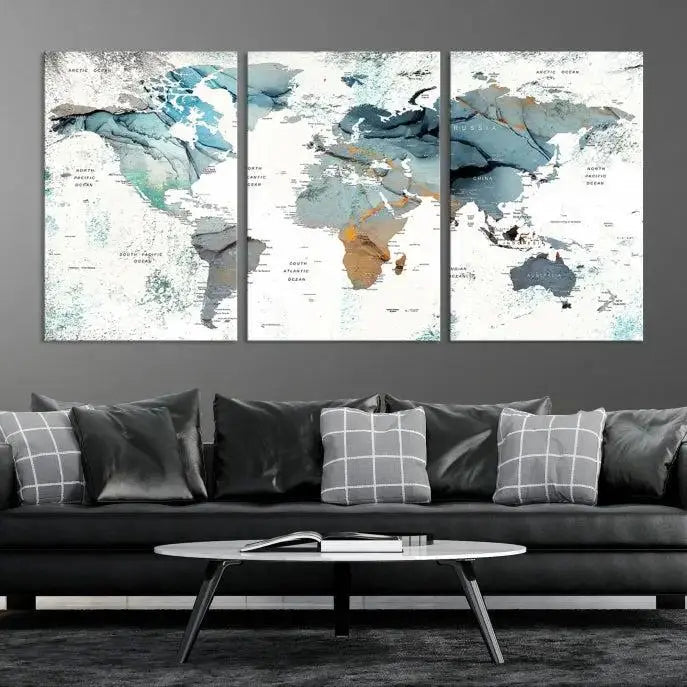 The Watercolor Push Pin World Map Wall Art, a world map painting on museum-quality canvas in blue and gray hues with a UV-protective coating, hangs prominently in the room.