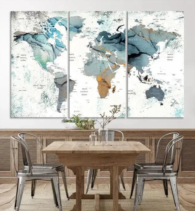 The Watercolor Push Pin World Map Wall Art, a world map painting on museum-quality canvas in blue and gray hues with a UV-protective coating, hangs prominently in the room.