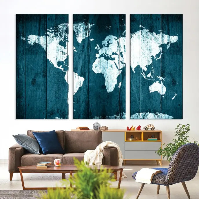 A living room showcases an elegant display of the Watercolor Wall Art World Map Canvas Print, spread across three panels above the sofa. Each piece of art comes with a UV-protective coating and is ready to hang.