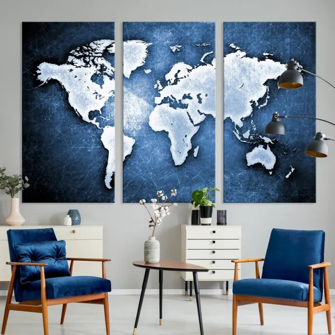 The Watercolor Wall Art World Map Canvas Print, a three-piece gallery wrapped on museum-quality canvas with a UV-protective coating, enhances a blue wall above the living space.