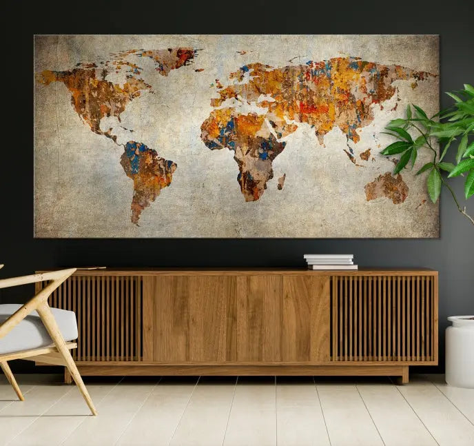 A triptych of Watercolor World Map Canvas Wall Art Prints is displayed in a dimly lit room.