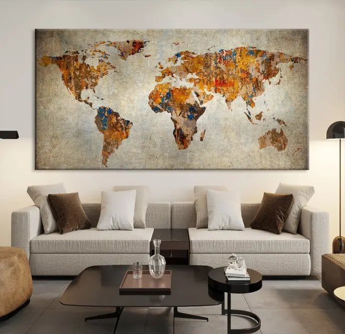 A triptych of Watercolor World Map Canvas Wall Art Prints is displayed in a dimly lit room.