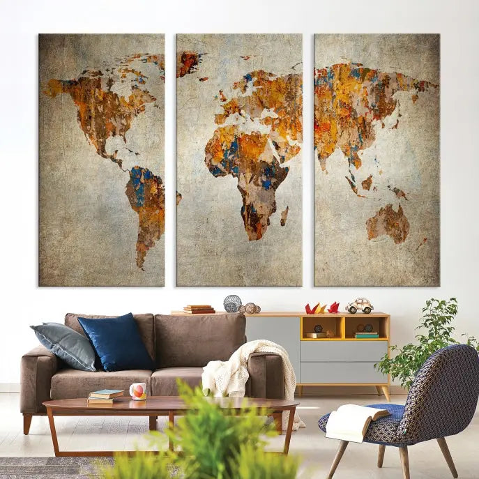 A triptych of Watercolor World Map Canvas Wall Art Prints is displayed in a dimly lit room.