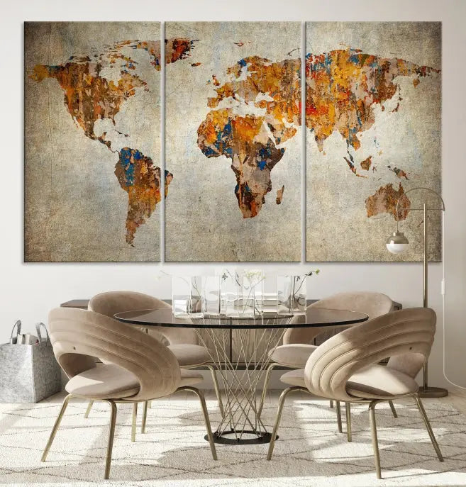 A triptych of Watercolor World Map Canvas Wall Art Prints is displayed in a dimly lit room.