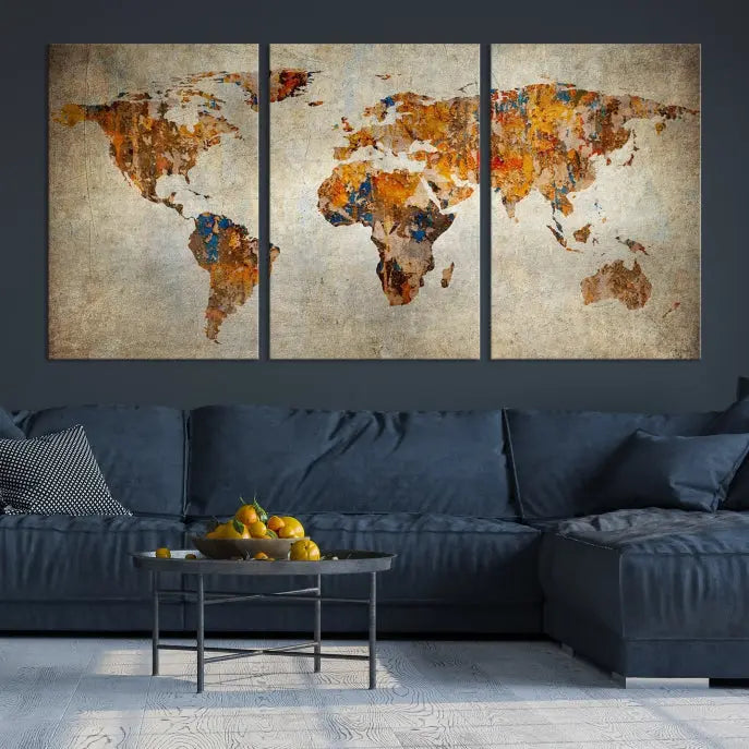 A triptych of Watercolor World Map Canvas Wall Art Prints is displayed in a dimly lit room.