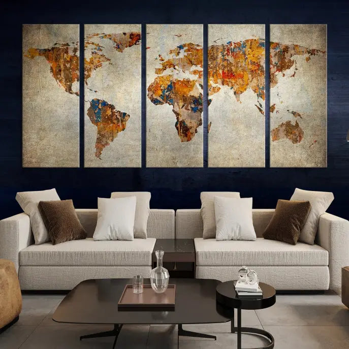 A triptych of Watercolor World Map Canvas Wall Art Prints is displayed in a dimly lit room.