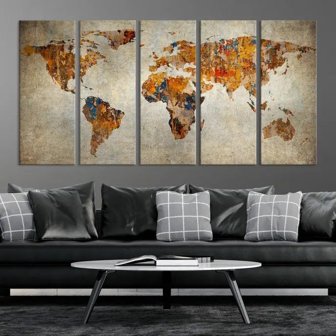 A triptych of Watercolor World Map Canvas Wall Art Prints is displayed in a dimly lit room.