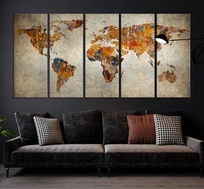 A triptych of Watercolor World Map Canvas Wall Art Prints is displayed in a dimly lit room.