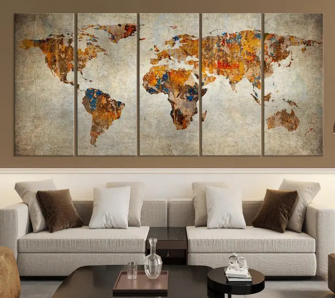 A triptych of Watercolor World Map Canvas Wall Art Prints is displayed in a dimly lit room.